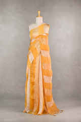 yellow gold and silver checkered organza silk tissue saree draped on a mannequin against a gray background