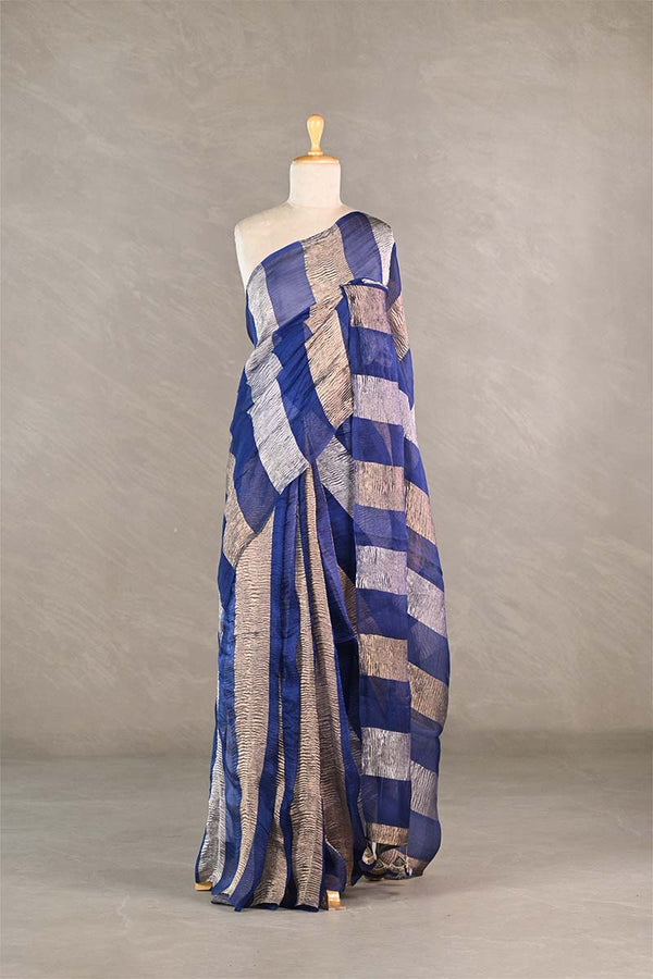 Mannequin wearing a blue and beige patterned dress against a plain background
