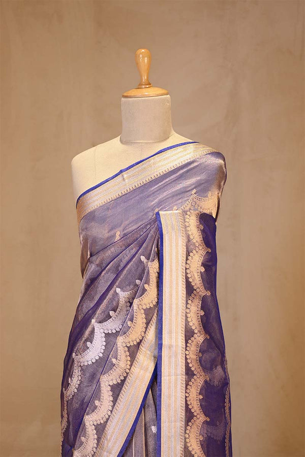 A Blue party wear tissue silk saree on dummy