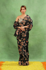 Women wearing Black Applique Organza Silk Saree showing multicolor floral vine jaal and scalloped border details.