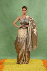 Women Wearing Reception Wear Steel Blue Brocade Tissue Silk Saree showing ethnic geometrical gold zari Tanchoi weaving and 1-inch border.