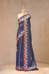Close up of Denim Blue Tussar Silk Saree showing printed Ashwamedh motifs on the body and a galloping horse print border framed by scalloped resham bands.