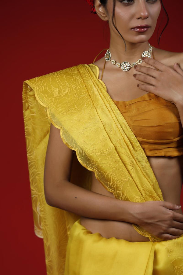 Woman wearing a yellow saree with a red background