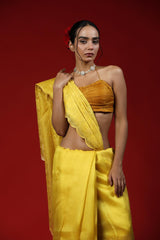 A woman wearing a yellow saree against a red background, promoting Party wear saree