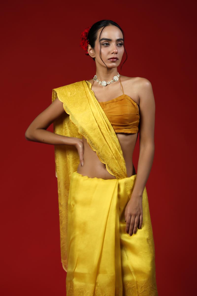 Woman wearing a yellow saree with a red background