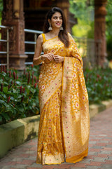Indian women draped  beautifully Bright Yellow Meenadar Handwoven Banarasi Silk Saree by chinaya banaras