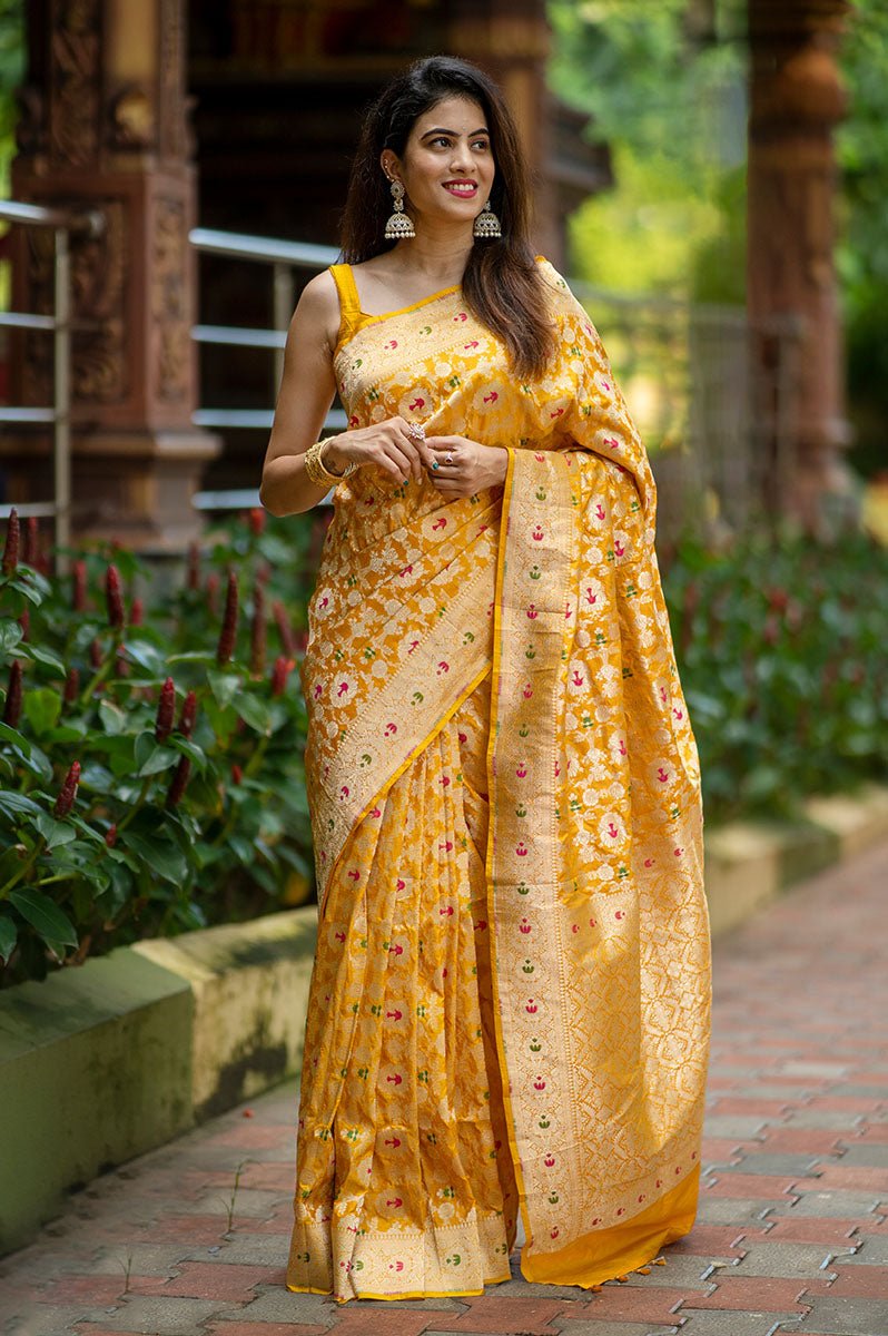 Indian women draped  beautifully Bright Yellow Meenadar Handwoven Banarasi Silk Saree by chinaya banaras